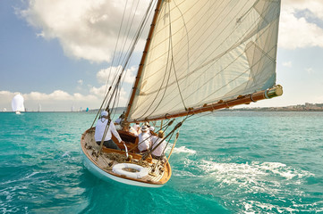 Sailboat under white sails at the regatta. Sailing yacht race