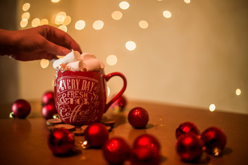 on the table is a cup with a drink and marshmallows