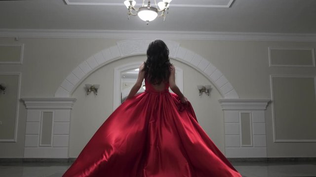 Beautiful woman in a red dress posing. Fashion and style concept.