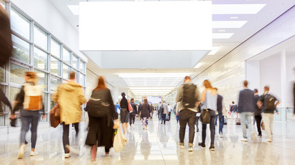Blank advertising space on trade fair or congress over people