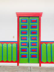 Colorful door of a traditional house of Salento in Colombia wit