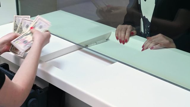 Employees And Clients Count Money On A Counter At The Currency Exchange Office. Female Hands With Money In Cash Department Window.