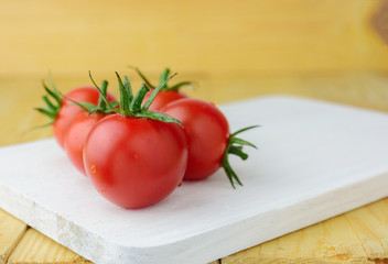 fresh tomato on wood background