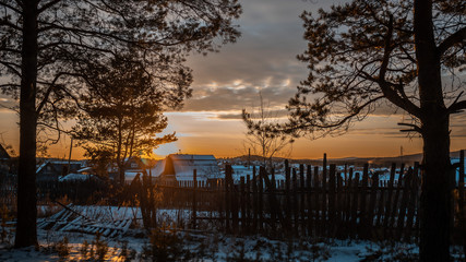 sunset in the village winter in the forest landscape russia