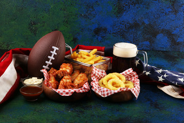 chicken wings, fries and onion rings for football on a table. Great for Bowl Game party