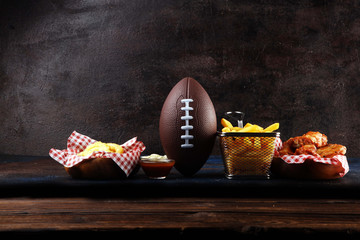 chicken wings, fries and onion rings for football on a table. Great for Bowl Game party
