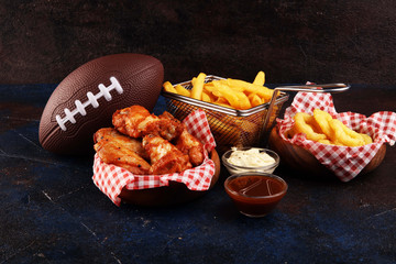chicken wings, fries and onion rings for football on a table. Great for Bowl Game party
