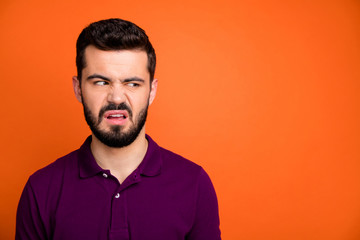 Close up photo of sad upset guy look copyspace dislike view scent he smell grimace frown face wear stylish clothes isolated over orange color background