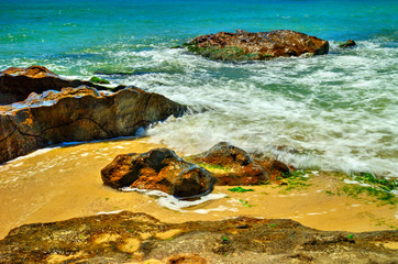 Beautiful landscape with rocks and sea waves on a sunny beach