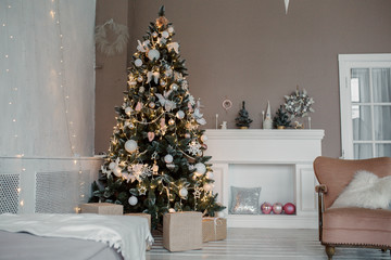 Decorated for the new year interior of the house-the General plan. Christmas tree and decorated Studio, lights garlands, decorations, gift boxes in a cozy home.