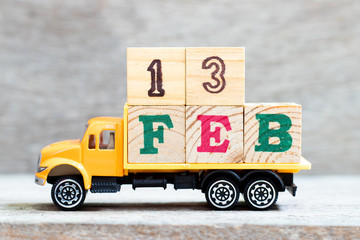 Truck hold letter block in word 13feb on wood background (Concept for date 13 month February)