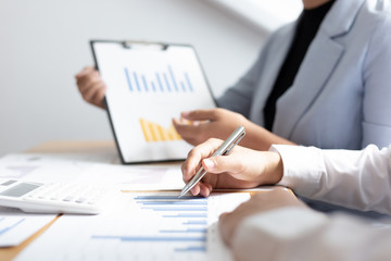 Meeting a team of businessmen, Executives and accountants meeting about the company's revenue graph in the office with laptops and calculators, Finance concept