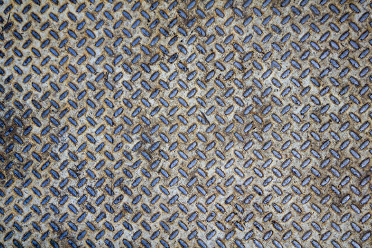 old white rusty metal plate with blue diagonal relief. rough surface texture