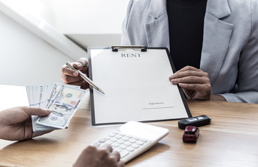 The car salesman handed the keys to the customer who passed the car purchase loan conditions ,Car...