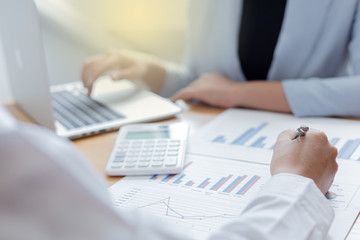 Fototapeta premium Meeting a team of businessmen, Executives and accountants meeting about the company's revenue graph in the office with laptops and calculators, Finance concept