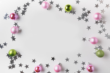 Christmas frame of silver and pink balls on white. Top view. Xmas border for wishes. Greeting card.