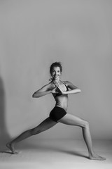 Fototapeta premium Girl doing yoga poses, poster ready, artistic black and white photo, fitness yoga instructor 