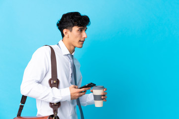 Young Argentinian businessman over isolated blue background