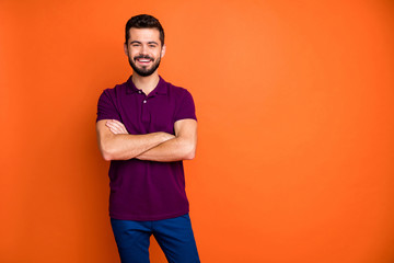 Portrait of charming guy have summer weekends cross hands enjoy free time wear modern good looking clothing isolated over orange color background