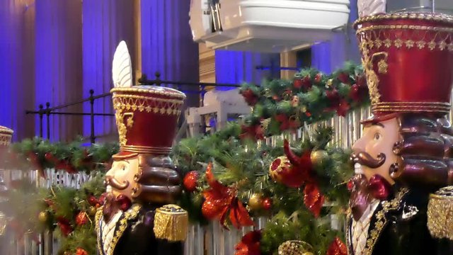 Christmas market nutcracker king soldier figures outside Ferris wheel entrance at festivity market.