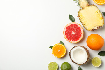 Flat lay with exotic fruits on white background, space for text