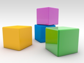 Fototapeta premium Four colored toy cubes on a white background