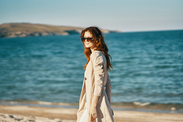 young woman in sunglasses on the beach