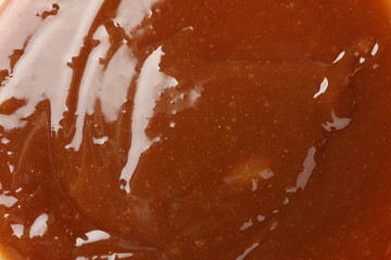 Brown caramel textured background, close up. Backdrop for design