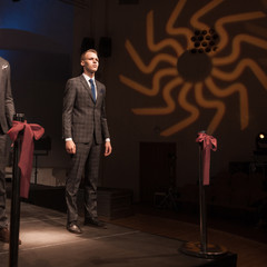 two attractive male models in a stylish suit during a fashion show