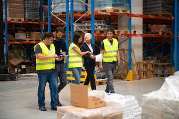 Working in warehouse, managers and workers