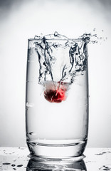 cherry in a glass of water splash