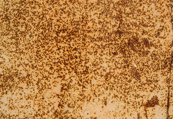 Painted yellow, old rusty metal surface with scratches and stains. Abstract background, texture.