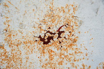 Old metal surface with peeling gray paint and rust stains.  Abstract background, texture.
