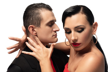 passionate dancer touching neck of sensual partner while performing tango isolated on white