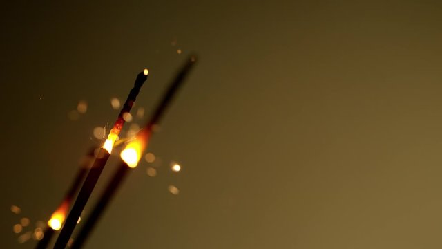 Burning sparklers on black background. Super Slow Motion. Filmed on high speed cinema camera, 1000fps.