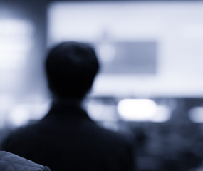 Blurred De-focused Audience in Conference Lecture Presentation Room. Corporate Presentations in Conference Hall. Seminar Speaker Giving Training to New Employees.