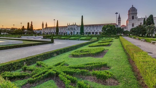 Mosteiro dos Jeronimos at sunset timelapse (Hieronymites Monastery) with green lawn in garden, located in the Belem district of Lisbon, Portugal. Typical example of the Manueline style. UNESCO World