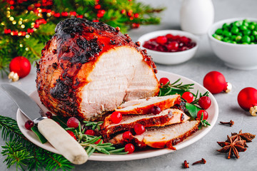 Christmas Glazed Ham with cranberry sauce. Roasted Holiday Pork Meat.