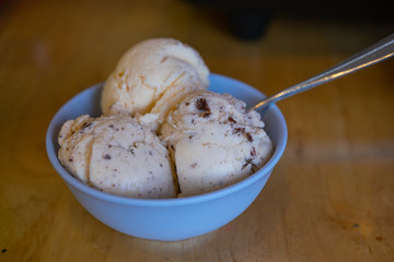 The different flavor ice cream scoops side view on wooden table background