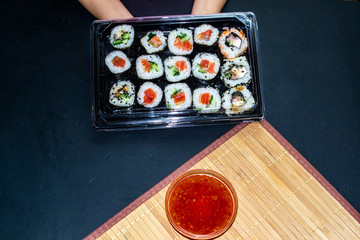 red fish sushi on a wooden tray