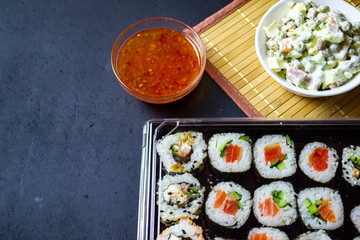 red fish sushi on a wooden tray