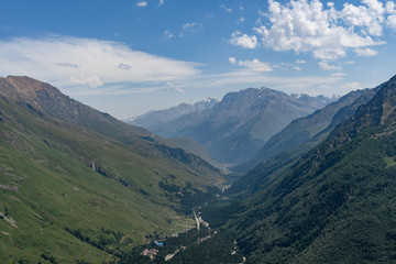 Fototapeta premium Green river valley from the height. Views of mountains and forests. Russia And The Caucasus. Elbrus