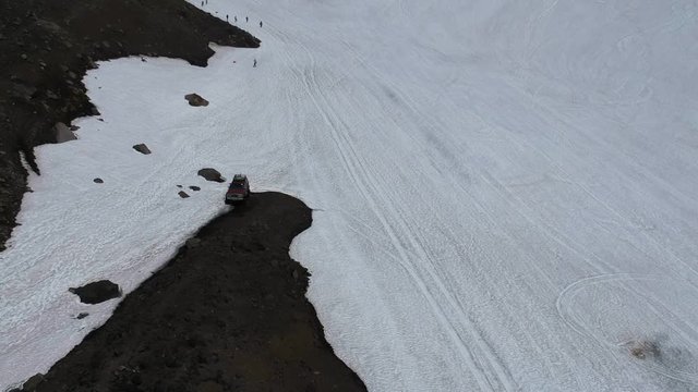 Russia, Kamchatka, snow-covered path to the Avachinsky volcano. Кув car goes off-road. Dangerous adventure. Extreme journey.