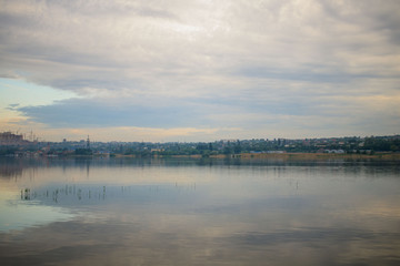 reflection clouds in river on the sunset
