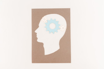 top view of human head silhouette with blue gear isolated on white