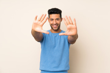 Fototapeta premium Young handsome man over isolated background counting ten with fingers