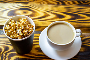 popcorn cornflakes with a cup of coffee, top view, selective focus