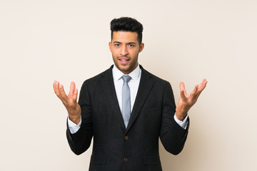 Young handsome businessman man over isolated background unhappy and frustrated with something