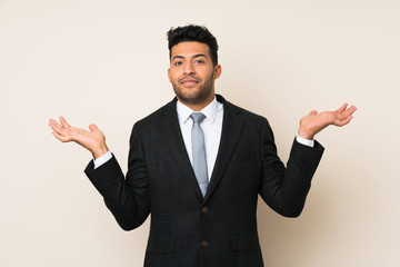 Young handsome businessman man over isolated background having doubts with confuse face expression
