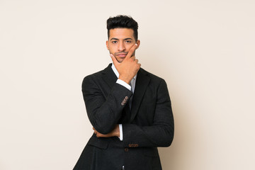 Young handsome businessman man over isolated background thinking an idea